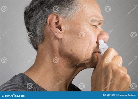 Man Using A Nasal Spray For His Nose Stock Image Image Of Face