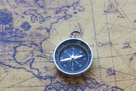 Classic Round Compass On Background Of Old Vintage Map Of World Stock