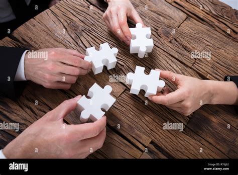 Group Of Businesspeople Solving Jigsaw Puzzle Stock Photo Alamy