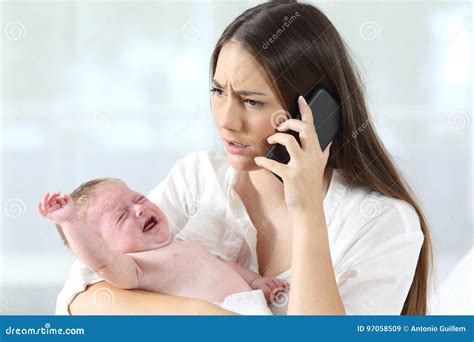 Mother Calling To A Doctor Worried About Her Baby Crying Stock Image