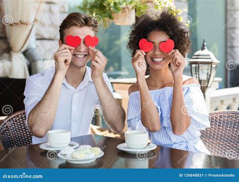 Happy Interracial Couple With Paper Hearts In Cafe Stock Image Image Of Covering Girlfriend