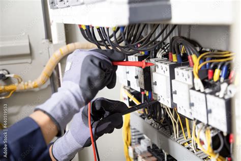 Electrician Engineer Tests Electrical Installations And Wires On Relay