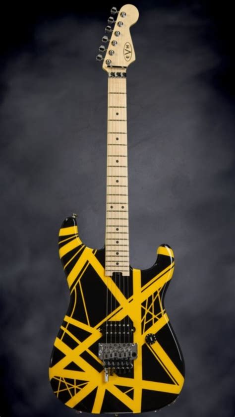 An Electric Guitar With Yellow And Black Strips On Its Body Against A