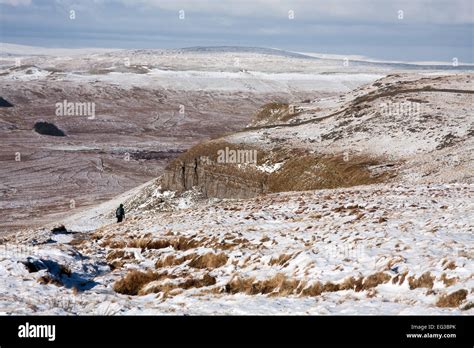 A walker descends Pen-y-ghent in winter Stock Photo - Alamy