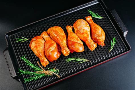 Raw Chicken Legs In A Marinade With Rosemary And Pepper Cooking