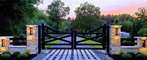 A Stone And Wood Gate With Lights On It