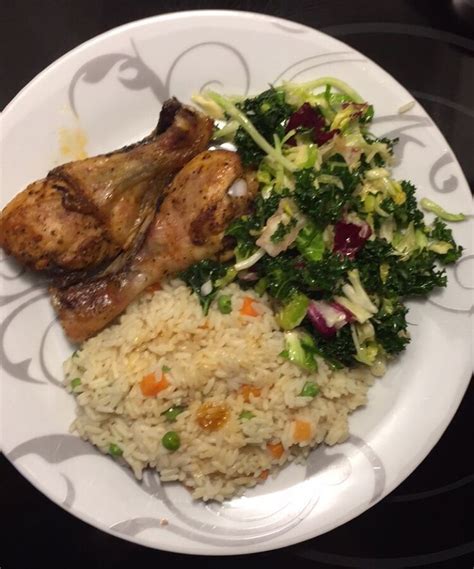 A White Plate Topped With Rice Meat And Veggies Next To Broccoli