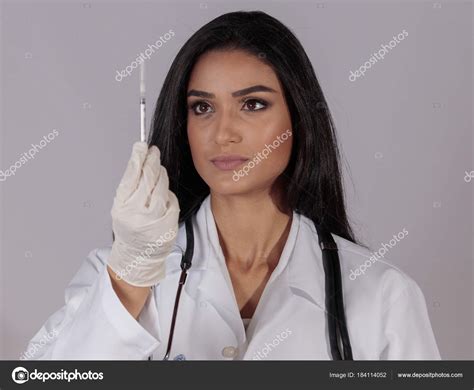 Pretty Brunette Female Doctor Watching Syringe Stock Photo Motuspix