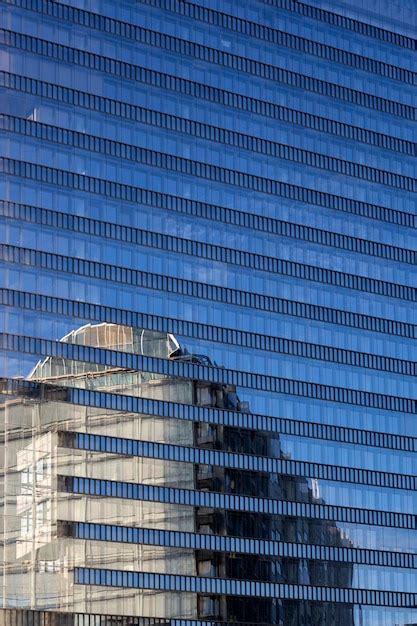 La Fachada De Un Edificio Moderno De Varias Plantas Con Reflejos En Las