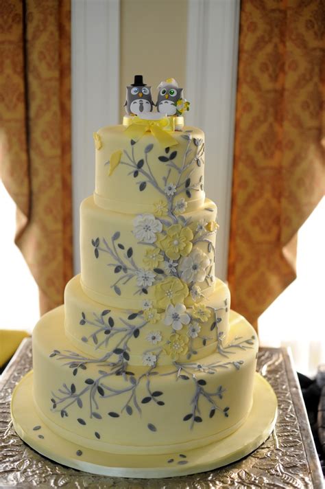 A Three Tiered Cake With Yellow Flowers On It