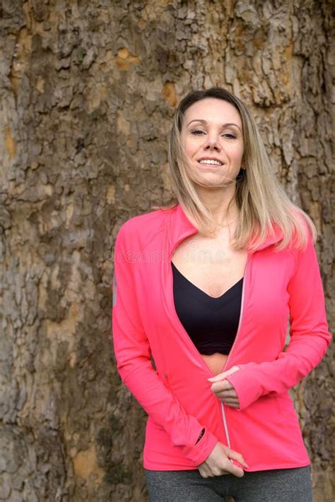 Blonde Woman Relaxing In Front Of A Tree Stock Photo Image Of Sporty Ponytail