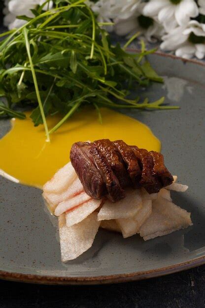 Premium Photo Tasty Duck Breast With Caramelized Pear And Arugula