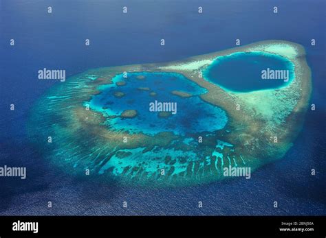 Aerial view of the coral reef which builds a lagoon in the atoll ...