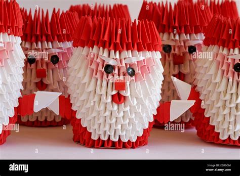 Rows Of Origami Santa Claus Father Christmas Decorations Set On White