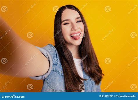 Close Up Of Young Beautiful Woman Shoot Selfie Show Tongue On Yellow