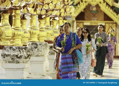 A Group Of Burmese People Are Carrying Flowers To Pay Respect To Buddha