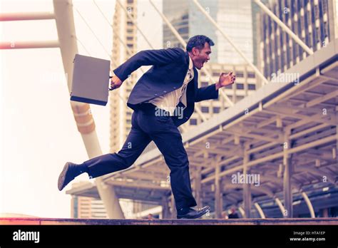 Man In Suit Briefcase Running Hi Res Stock Photography And Images Alamy