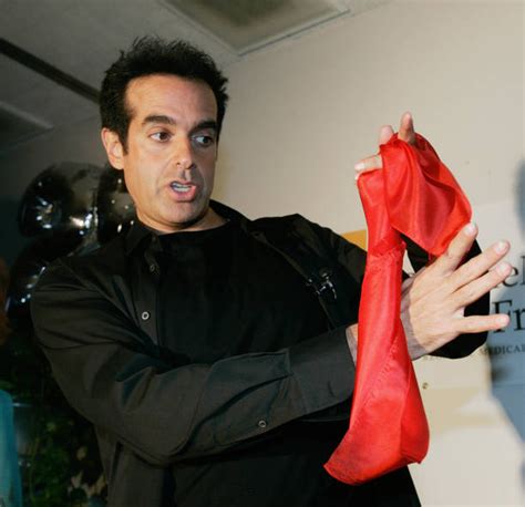 Entertainer David Copperfield performs magic tricks in front of an... | David