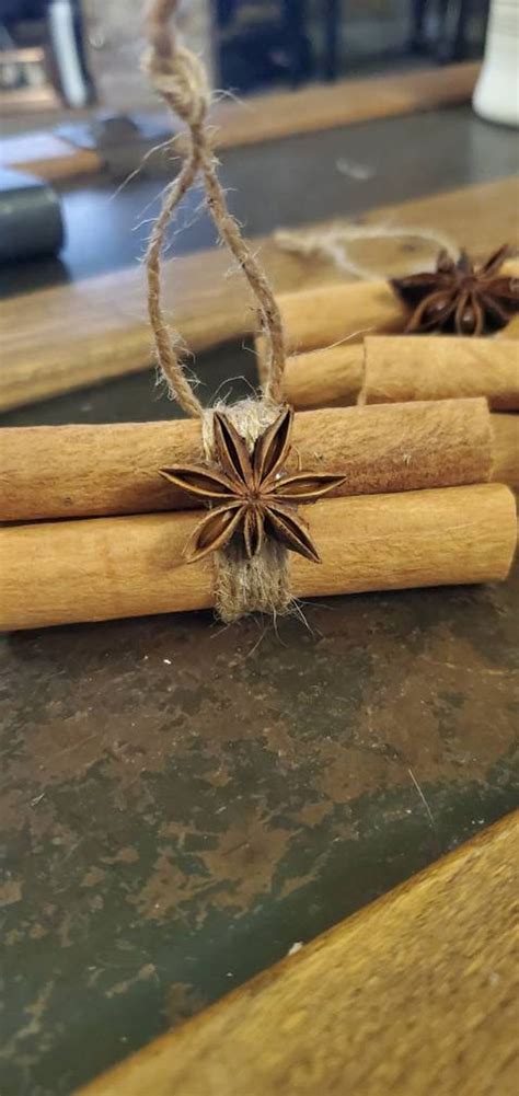 Cinnamon Sticks Tied With Twine And Star Anise On Top Of A Wooden Table