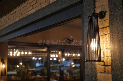 elegant wall lamp illuminating  cozy restaurant entrance  night