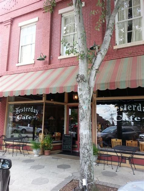 The Outside Of A Restaurant With Tables And Chairs