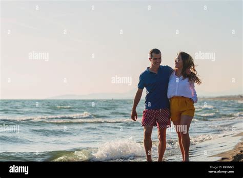 Happy Romantic Middle Aged Couple Enjoying Beautiful Sunset Walk On The