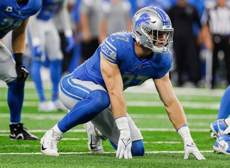 A Football Player Kneeling Down On The Field