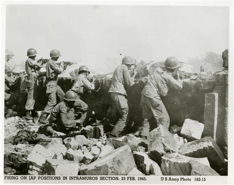 US Army soldiers shooting from behind a war-damaged wall, Manila, 1945 ...