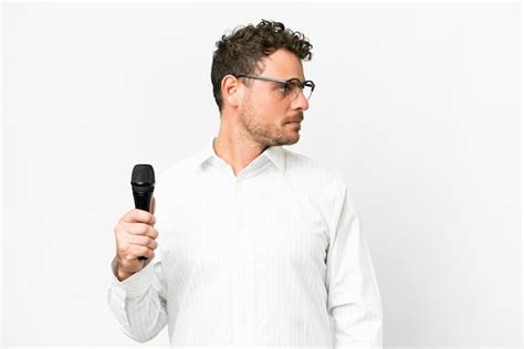 Premium Photo Brazilian Man Picking Up A Microphone Over Isolated