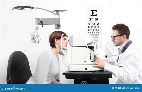 Optometrist Examining Eyesight Patient In Optician Office On Wh Stock