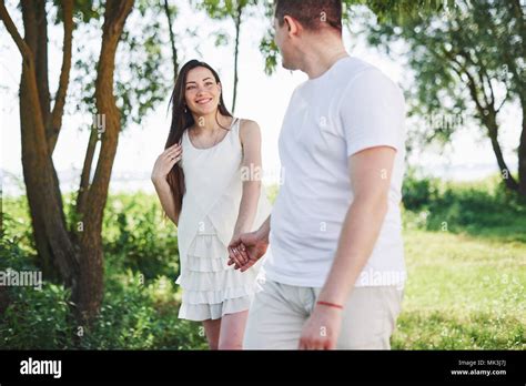 Happy And Young Pregnant Couple Hugging In Nature Romantic Moments