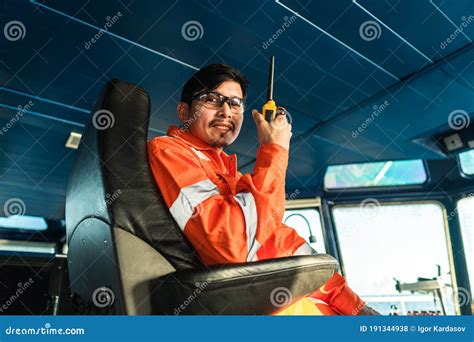 Filipino Deck Officer On Bridge Of Vessel Or Ship He Is Speaking On