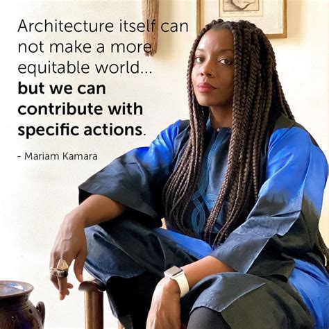 A Woman Sitting On Top Of A Chair Next To A Wall With A Quote About Architecture