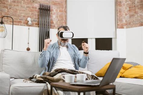 Premium Photo Excited Mature Man Sitting On Sofa In Vr Goggles