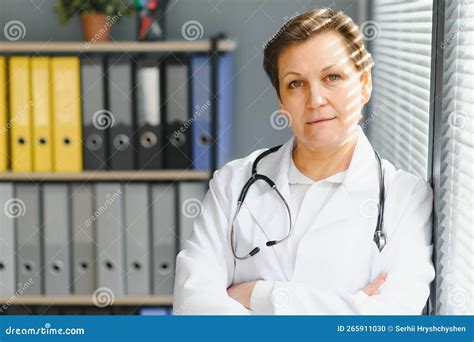 Portrait Of Middle Age Female Doctor Is Wearing A White Doctor S Coat With A Stethoscope Around