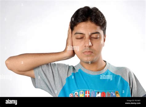 South Asian Indian Man Doing Exercise Closing Eyes Keeping Right Hand