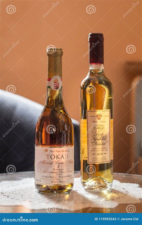 Two Bottles of Tokaji Wine on a Fancy Glass Table. Tokay is a White Sweet Wine from the Tokaji ...