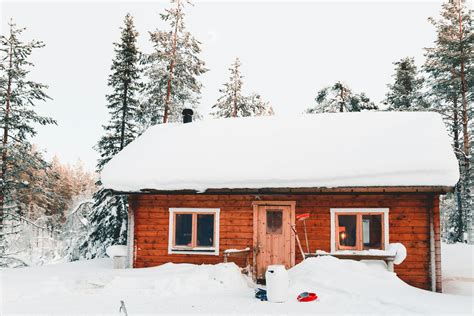 Brown Wooden Cabin In Snowy Landscape Near Forest · Free Stock Photo