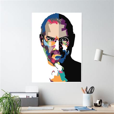 A Portrait Of Steve Jobs Is Shown On A Wall Above A Desk With Office