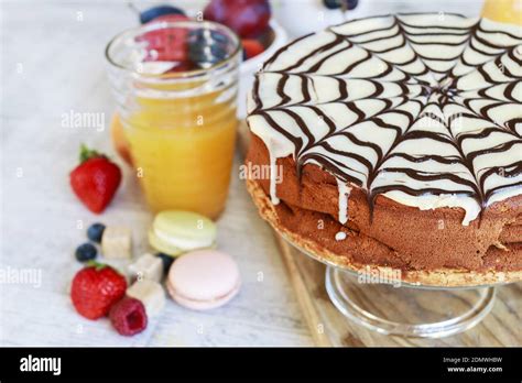 Halloween Chocolate Spider Web Cake And Various Fruits Around Party