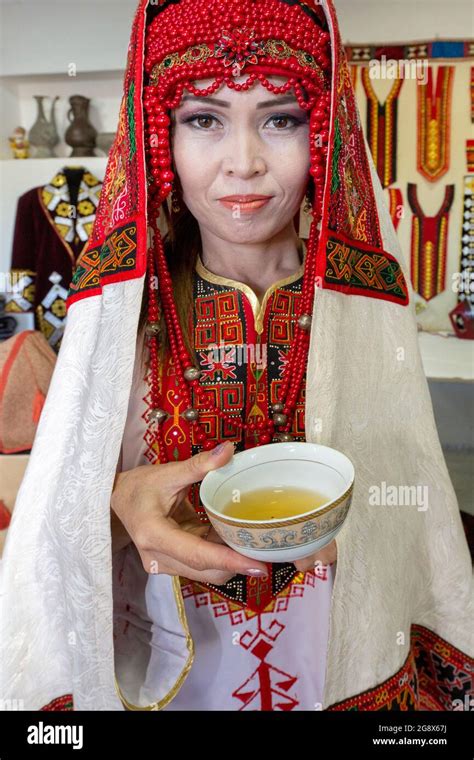 Uzbek Woman In Traditional Wedding Dress Offering Tea In Nukus