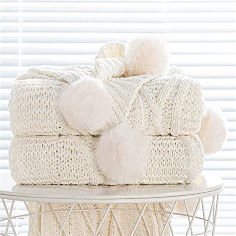 Stay Warm And Cozy With A Chunky Knit Blanket With Pom Poms