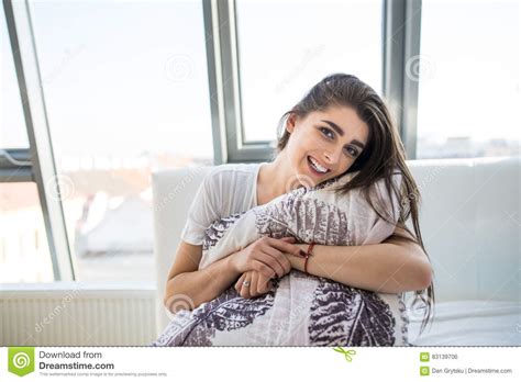 Brunette Hugging Her Pillow At Home In The Bedroom Stock Photo Image Of Brown Bedroom