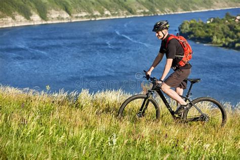 Attractive Cyclist Riding The Mountain Bicyclist On The Summer Trail