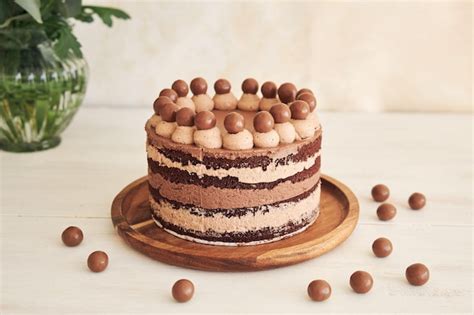 Premium Photo Delicious Chocolate Naked Cake With Choco Balls And Cream On A White Table