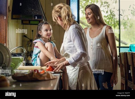 Mature Woman Talking With Her Granddaughter In Kitchen Stock Photo Alamy