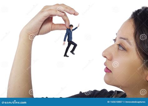 Tiny Man Trapped And Being Held By Giant Female Hands Stock Image