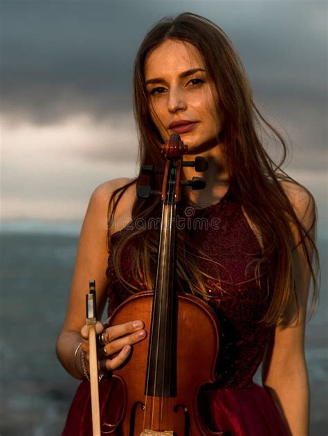 Charming Caucasian Woman With Violin On The Beach Music And Art