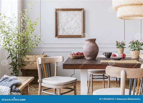 Clay Vase On The Table In A Dining Room Interior With A Plant Chairs