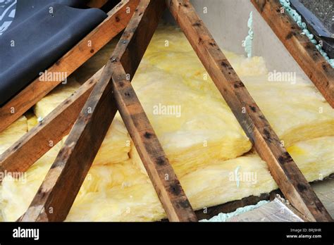 Timber Hip Roof Trusses And Fibreglass Insulation Seen From Outside